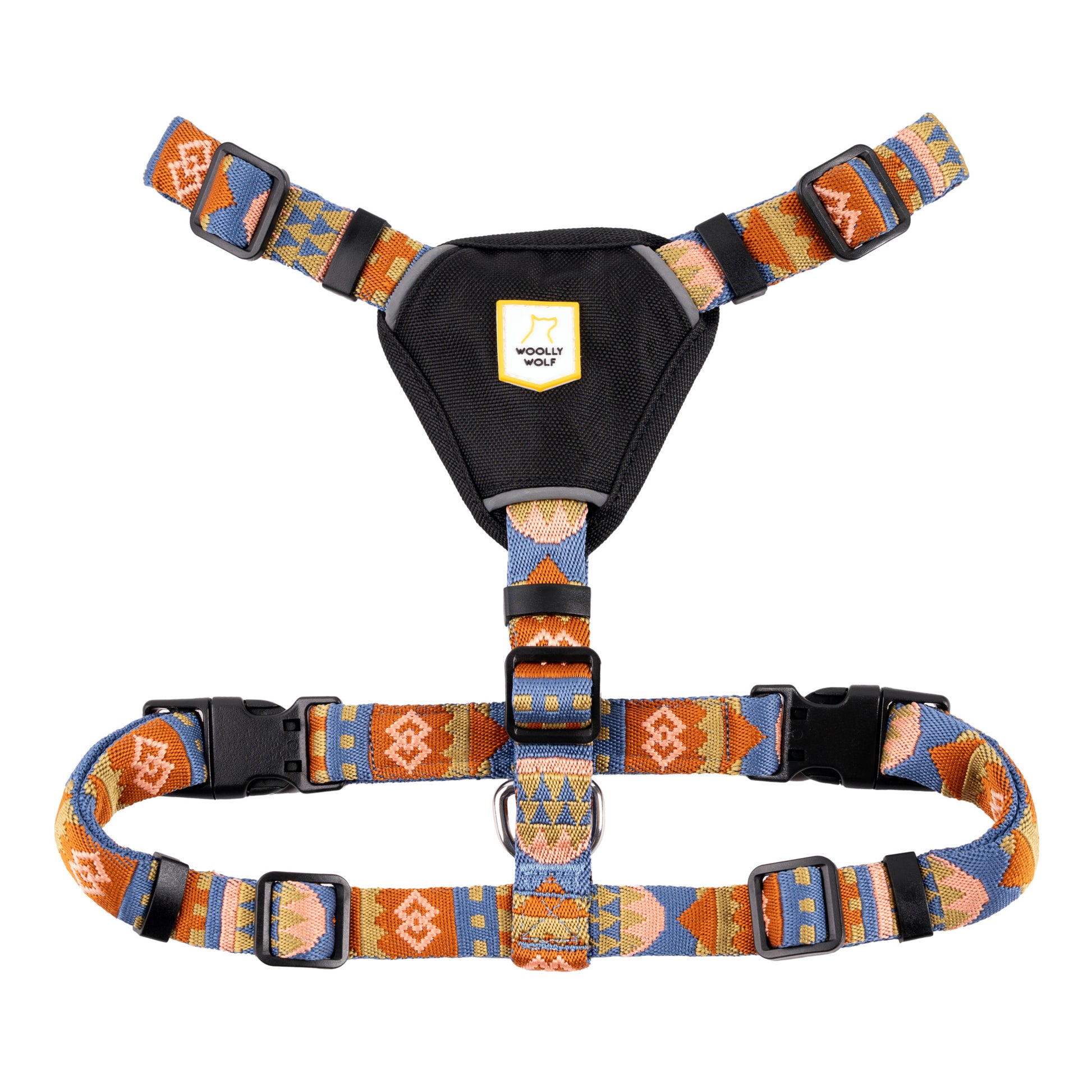 Colorful patterned dog harness with black chest pad and adjustable straps, featuring plastic buckles.