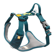 The Roam Dog Harness Deep Teal features teal and gray padded material, adjustable straps, a plastic buckle, metal rings, and reinforced stitching for comfortable and secure pet walks.