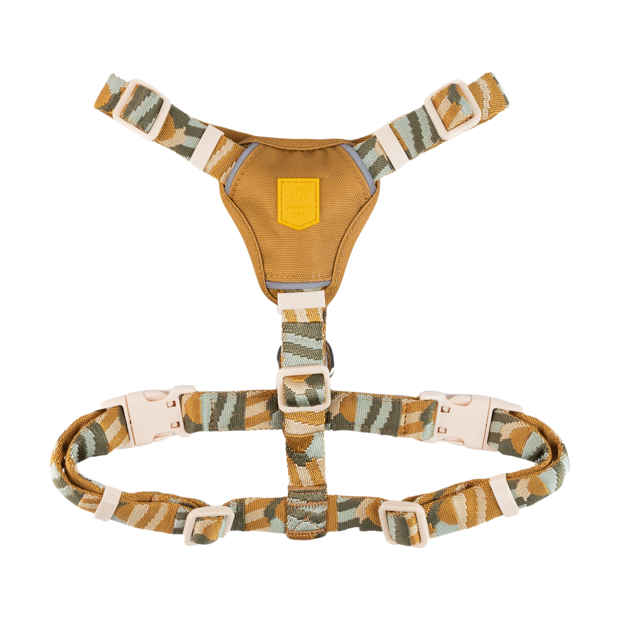 A camouflage-patterned dog harness with adjustable straps and plastic buckles on a white background.